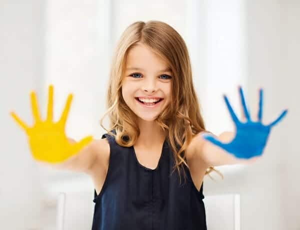 The cutest little girl with paint on her hands.
