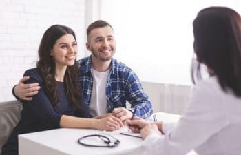 Young couple talking with a medical professional